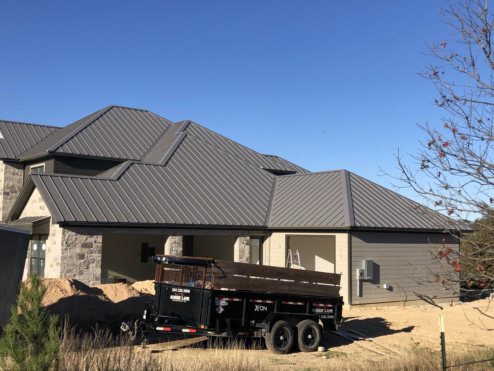 Finished metal roof on a brick home in Leander, TX