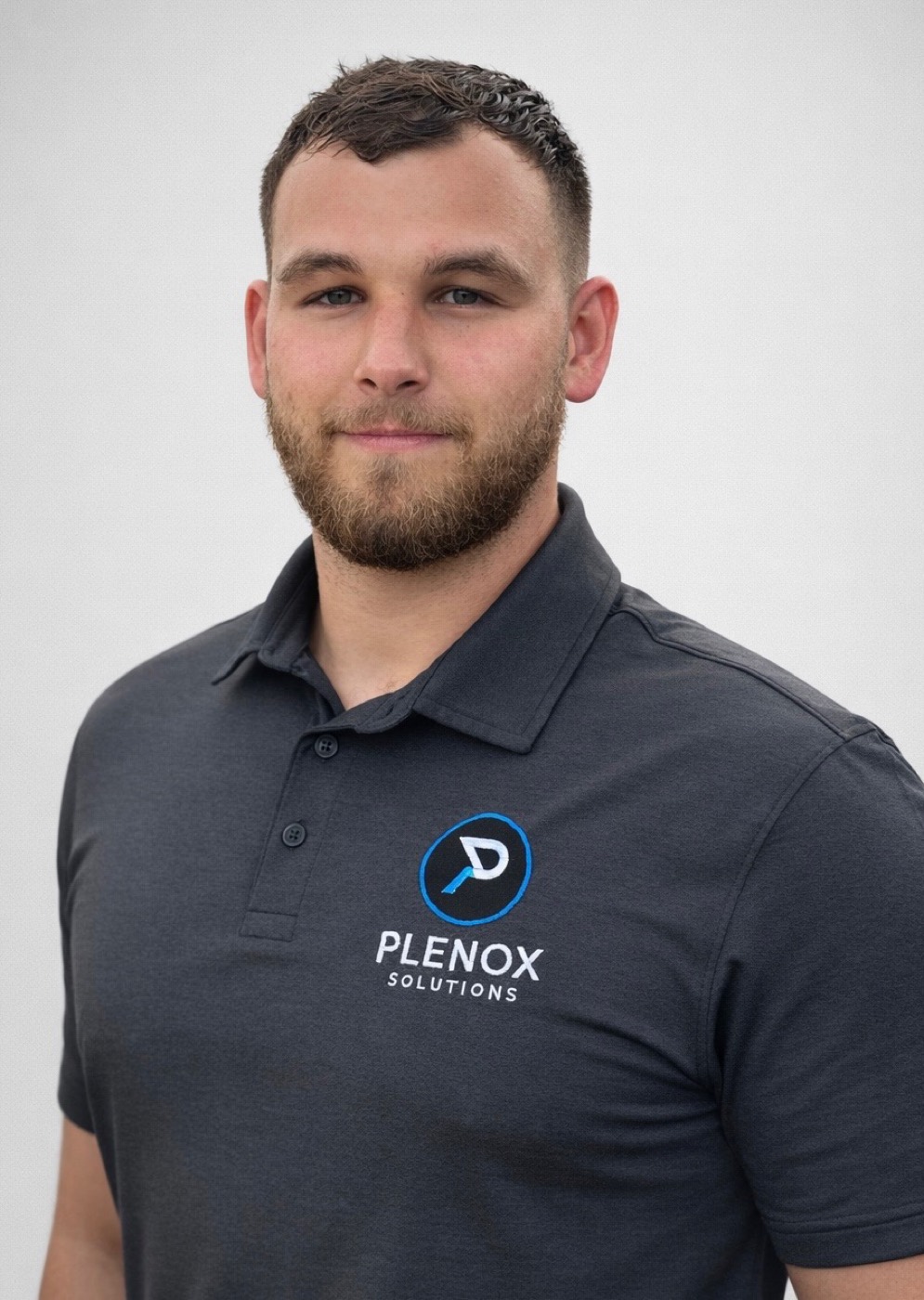 Plenox Solutions roofer in branded polo in Leander, TX