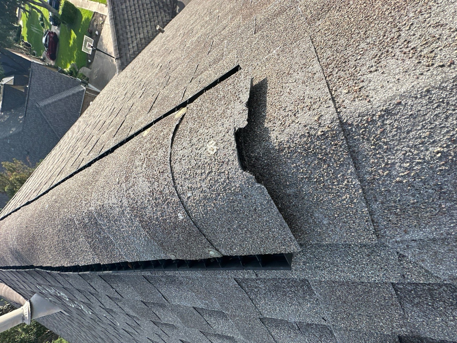 Wind damaged roof with blown-off shingles in Leander, TX