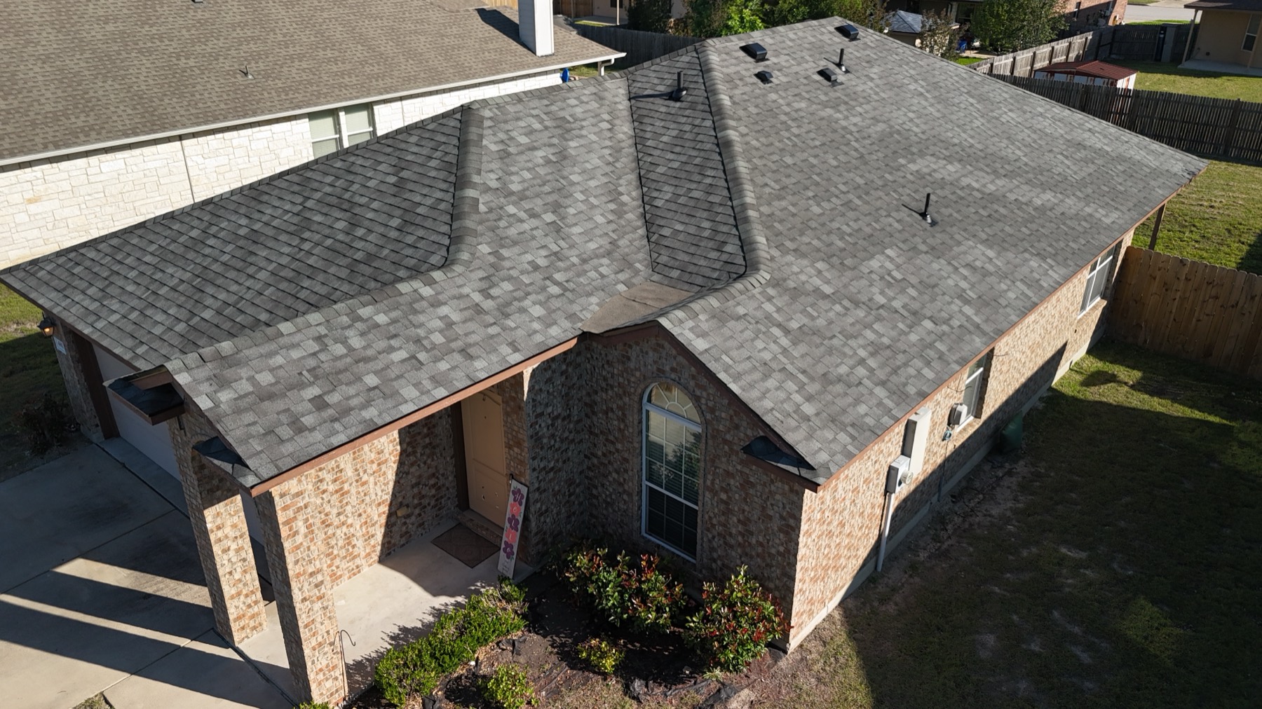 Aerial of a finished metal roof on a brick home in Leander, TX